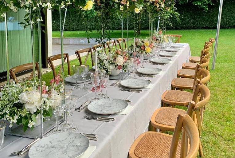 Pink, white, and yellow floral arrangements from a birthday party planned by Events by Loukia